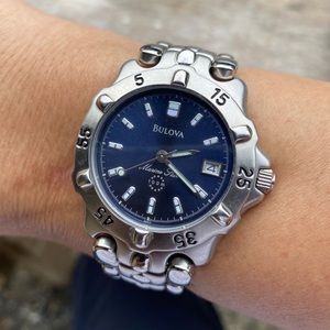 Vintage Bulova Marine Star 100m watch with luminous blue dial and rotating bezel